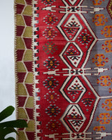 Vintage kilim rug in room decor setting, old rug, antique rug, pastel colors, faded colors, Turkish rug, vintage rug, soft rug, Portland, Oregon, rug store, rug shop, local shop, bold colors, bright colors, faded colors