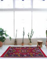 Vintage Turkish rug in a living room setting, pile rug, Turkish rug, vintage rug, portland, rug shop, bright colors, wild shaman, soft rug, bold color, Portland, Oregon, rug store, rug shop, local shop, antique rug