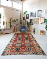 Vintage kilim rug in room decor setting, old rug, antique rug, pastel colors, faded colors, Turkish rug, vintage rug, soft rug, Portland, Oregon, rug store, rug shop, local shop, bold colors, bright colors, faded colors