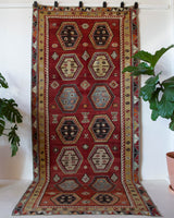 Vintage kilim rug in room decor setting, old rug, antique rug, pastel colors, faded colors, Turkish rug, vintage rug, soft rug, Portland, Oregon, rug store, rug shop, local shop, bold colors, bright colors, faded colors