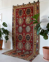 Vintage kilim rug in room decor setting, old rug, antique rug, pastel colors, faded colors, Turkish rug, vintage rug, soft rug, Portland, Oregon, rug store, rug shop, local shop, bold colors, bright colors, faded colors