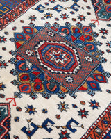 Vintage Turkish rug in a living room setting, pile rug, Turkish rug, vintage rug, portland, rug shop, bright colors, wild shaman, soft rug, bold color, Portland, Oregon, rug store, rug shop, local shop, antique rug