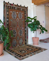 Vintage kilim rug in living room setting, old rug, antique rug, pastel colors, faded colors, Turkish rug, vintage rug, soft rug, Portland, Oregon, rug store, rug shop, local shop, earthy tones, earthy colors, warm colors
