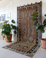 Vintage kilim rug in living room setting, old rug, antique rug, pastel colors, faded colors, Turkish rug, vintage rug, soft rug, Portland, Oregon, rug store, rug shop, local shop, earthy tones, earthy colors, warm colors