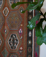 Vintage kilim rug in living room setting, old rug, antique rug, pastel colors, faded colors, Turkish rug, vintage rug, soft rug, Portland, Oregon, rug store, rug shop, local shop, earthy tones, earthy colors, warm colors