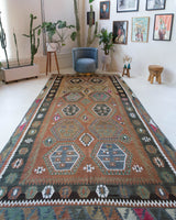 Vintage kilim rug in living room setting, old rug, antique rug, pastel colors, faded colors, Turkish rug, vintage rug, soft rug, Portland, Oregon, rug store, rug shop, local shop, earthy tones, earthy colors, warm colors