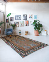 Vintage kilim rug in living room setting, old rug, antique rug, pastel colors, faded colors, Turkish rug, vintage rug, soft rug, Portland, Oregon, rug store, rug shop, local shop, earthy tones, earthy colors, warm colors