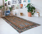 Vintage kilim rug in living room setting, old rug, antique rug, pastel colors, faded colors, Turkish rug, vintage rug, soft rug, Portland, Oregon, rug store, rug shop, local shop, earthy tones, earthy colors, warm colors