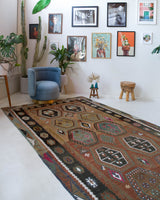 Vintage kilim rug in living room setting, old rug, antique rug, pastel colors, faded colors, Turkish rug, vintage rug, soft rug, Portland, Oregon, rug store, rug shop, local shop, earthy tones, earthy colors, warm colors