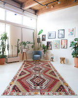 Vintage kilim rug in living room setting, old rug, antique rug, pastel colors, faded colors, Turkish rug, vintage rug, soft rug, Portland, Oregon, rug store, rug shop, local shop, earthy tones, earthy colors, warm colors