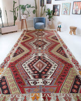 Vintage kilim rug in living room setting, old rug, antique rug, pastel colors, faded colors, Turkish rug, vintage rug, soft rug, Portland, Oregon, rug store, rug shop, local shop, earthy tones, earthy colors, warm colors