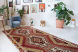 Vintage kilim rug in living room setting, old rug, antique rug, pastel colors, faded colors, Turkish rug, vintage rug, soft rug, Portland, Oregon, rug store, rug shop, local shop, earthy tones, earthy colors, warm colors