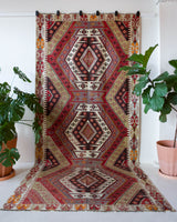 Vintage kilim rug in living room setting, old rug, antique rug, pastel colors, faded colors, Turkish rug, vintage rug, soft rug, Portland, Oregon, rug store, rug shop, local shop, earthy tones, earthy colors, warm colors