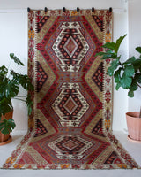 Vintage kilim rug in living room setting, old rug, antique rug, pastel colors, faded colors, Turkish rug, vintage rug, soft rug, Portland, Oregon, rug store, rug shop, local shop, earthy tones, earthy colors, warm colors