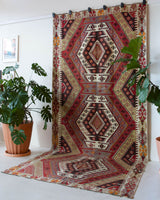 Vintage kilim rug in living room setting, old rug, antique rug, pastel colors, faded colors, Turkish rug, vintage rug, soft rug, Portland, Oregon, rug store, rug shop, local shop, earthy tones, earthy colors, warm colors