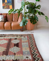 Vintage kilim rug in room decor setting, old rug, antique rug, pastel colors, faded colors, Turkish rug, vintage rug, soft rug, Portland, Oregon, rug store, rug shop, local shop, bold colors, bright colors, faded colors