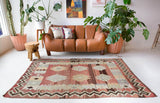 Vintage kilim rug in room decor setting, old rug, antique rug, pastel colors, faded colors, Turkish rug, vintage rug, soft rug, Portland, Oregon, rug store, rug shop, local shop, bold colors, bright colors, faded colors