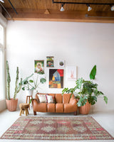 Vintage kilim rug in living room setting, old rug, antique rug, pastel colors, faded colors, Turkish rug, vintage rug, soft rug, Portland, Oregon, rug store, rug shop, local shop, earthy tones, earthy colors, warm colors