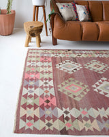 Vintage kilim rug in living room setting, old rug, antique rug, pastel colors, faded colors, Turkish rug, vintage rug, soft rug, Portland, Oregon, rug store, rug shop, local shop, earthy tones, earthy colors, warm colors