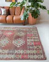 Vintage kilim rug in living room setting, old rug, antique rug, pastel colors, faded colors, Turkish rug, vintage rug, soft rug, Portland, Oregon, rug store, rug shop, local shop, earthy tones, earthy colors, warm colors