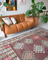 Vintage kilim rug in living room setting, old rug, antique rug, pastel colors, faded colors, Turkish rug, vintage rug, soft rug, Portland, Oregon, rug store, rug shop, local shop, earthy tones, earthy colors, warm colors