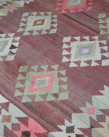 Vintage kilim rug in living room setting, old rug, antique rug, pastel colors, faded colors, Turkish rug, vintage rug, soft rug, Portland, Oregon, rug store, rug shop, local shop, earthy tones, earthy colors, warm colors