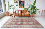 Vintage kilim rug in living room setting, old rug, antique rug, pastel colors, faded colors, Turkish rug, vintage rug, soft rug, Portland, Oregon, rug store, rug shop, local shop, earthy tones, earthy colors, warm colors