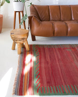 Vintage kilim rug in room decor setting, old rug, antique rug, pastel colors, faded colors, Turkish rug, vintage rug, soft rug, Portland, Oregon, rug store, rug shop, local shop, bold colors, bright colors, faded colors