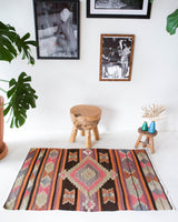 Vintage Turkish mini rug in room decor setting, old rug, antique rug, pastel colors, faded colors, Turkish rug, vintage rug, soft rug, Portland, Oregon, rug store, rug shop, local shop,  bright colors, bold colors