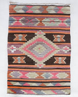 Vintage Turkish mini rug in room decor setting, old rug, antique rug, pastel colors, faded colors, Turkish rug, vintage rug, soft rug, Portland, Oregon, rug store, rug shop, local shop,  bright colors, bold colors