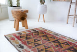Vintage Turkish mini rug in room decor setting, old rug, antique rug, pastel colors, faded colors, Turkish rug, vintage rug, soft rug, Portland, Oregon, rug store, rug shop, local shop,  bright colors, bold colors