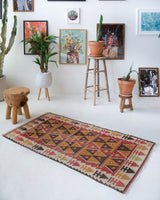 Vintage Turkish mini rug in room decor setting, old rug, antique rug, pastel colors, faded colors, Turkish rug, vintage rug, soft rug, Portland, Oregon, rug store, rug shop, local shop,  bright colors, bold colors