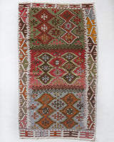 Vintage Turkish mini rug in room decor setting, old rug, antique rug, pastel colors, faded colors, Turkish rug, vintage rug, soft rug, Portland, Oregon, rug store, rug shop, local shop,  bright colors, bold colors