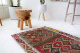 Vintage Turkish mini rug in room decor setting, old rug, antique rug, pastel colors, faded colors, Turkish rug, vintage rug, soft rug, Portland, Oregon, rug store, rug shop, local shop,  bright colors, bold colors