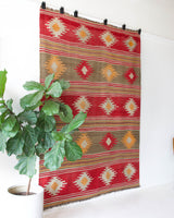 Vintage kilim rug in room decor setting, old rug, antique rug, pastel colors, faded colors, Turkish rug, vintage rug, soft rug, Portland, Oregon, rug store, rug shop, local shop, bold colors, bright colors, faded colors