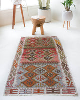 Vintage Turkish mini rug in room decor setting, old rug, antique rug, pastel colors, faded colors, Turkish rug, vintage rug, soft rug, Portland, Oregon, rug store, rug shop, local shop,  bright colors, bold colors