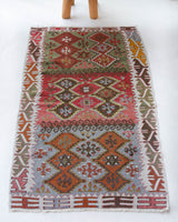 Vintage Turkish mini rug in room decor setting, old rug, antique rug, pastel colors, faded colors, Turkish rug, vintage rug, soft rug, Portland, Oregon, rug store, rug shop, local shop,  bright colors, bold colors