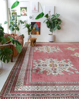 Area rug in a living room setting, pile rug, Turkish rug, old rug, antique rug, pastel colors, faded colors, Turkish rug, vintage rug, soft rug, Portland, Oregon, rug store, rug shop, local shop, distressed rug, worn out rug