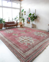 Area rug in a living room setting, pile rug, Turkish rug, old rug, antique rug, pastel colors, faded colors, Turkish rug, vintage rug, soft rug, Portland, Oregon, rug store, rug shop, local shop, distressed rug, worn out rug