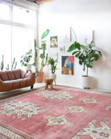 Area rug in a living room setting, pile rug, Turkish rug, old rug, antique rug, pastel colors, faded colors, Turkish rug, vintage rug, soft rug, Portland, Oregon, rug store, rug shop, local shop, distressed rug, worn out rug