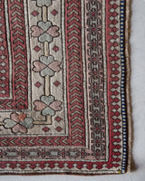 Area rug in a living room setting, pile rug, Turkish rug, old rug, antique rug, pastel colors, faded colors, Turkish rug, vintage rug, soft rug, Portland, Oregon, rug store, rug shop, local shop, distressed rug, worn out rug