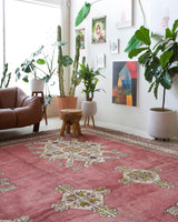 Area rug in a living room setting, pile rug, Turkish rug, old rug, antique rug, pastel colors, faded colors, Turkish rug, vintage rug, soft rug, Portland, Oregon, rug store, rug shop, local shop, distressed rug, worn out rug