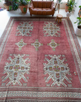 Area rug in a living room setting, pile rug, Turkish rug, old rug, antique rug, pastel colors, faded colors, Turkish rug, vintage rug, soft rug, Portland, Oregon, rug store, rug shop, local shop, distressed rug, worn out rug