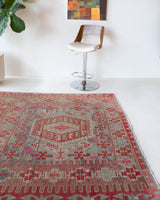 Vintage kilim rug in living room setting, old rug, antique rug, pastel colors, faded colors, Turkish rug, vintage rug, soft rug, Portland, Oregon, rug store, rug shop, local shop, earthy tones, earthy colors, warm colors