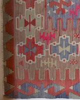 Vintage kilim rug in living room setting, old rug, antique rug, pastel colors, faded colors, Turkish rug, vintage rug, soft rug, Portland, Oregon, rug store, rug shop, local shop, earthy tones, earthy colors, warm colors