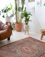 Vintage kilim rug in living room setting, old rug, antique rug, pastel colors, faded colors, Turkish rug, vintage rug, soft rug, Portland, Oregon, rug store, rug shop, local shop, earthy tones, earthy colors, warm colors