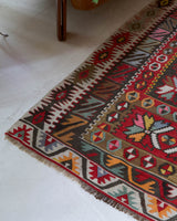 Vintage kilim rug in living room setting, old rug, antique rug, pastel colors, faded colors, Turkish rug, vintage rug, soft rug, Portland, Oregon, rug store, rug shop, local shop, earthy tones, earthy colors, warm colors