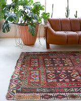 Vintage kilim rug in living room setting, old rug, antique rug, pastel colors, faded colors, Turkish rug, vintage rug, soft rug, Portland, Oregon, rug store, rug shop, local shop, earthy tones, earthy colors, warm colors