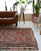 Vintage kilim rug in living room setting, old rug, antique rug, pastel colors, faded colors, Turkish rug, vintage rug, soft rug, Portland, Oregon, rug store, rug shop, local shop, earthy tones, earthy colors, warm colors