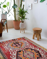 Vintage kilim rug in living room setting, old rug, antique rug, pastel colors, faded colors, Turkish rug, vintage rug, soft rug, Portland, Oregon, rug store, rug shop, local shop, earthy tones, earthy colors, warm colors